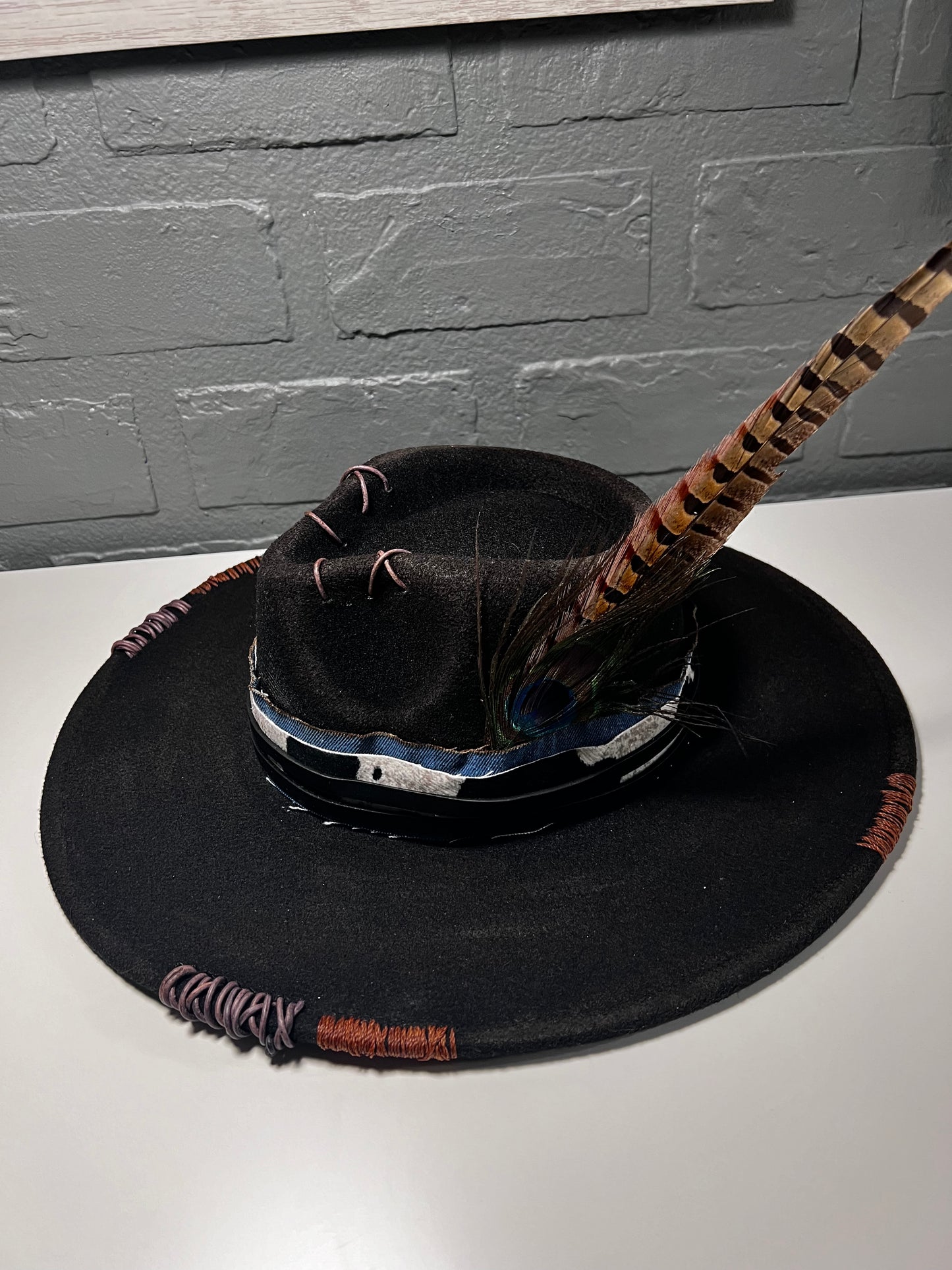 Black cowboy hat with cow print