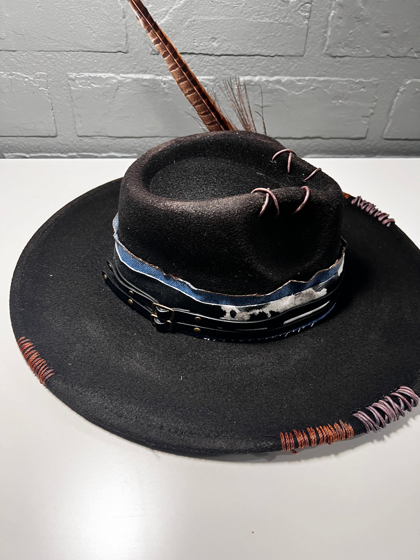 Black cowboy hat with cow print